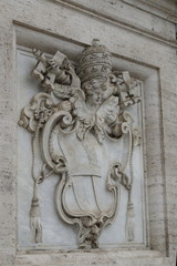Bas relief of Papal Coat of Arms on white marble