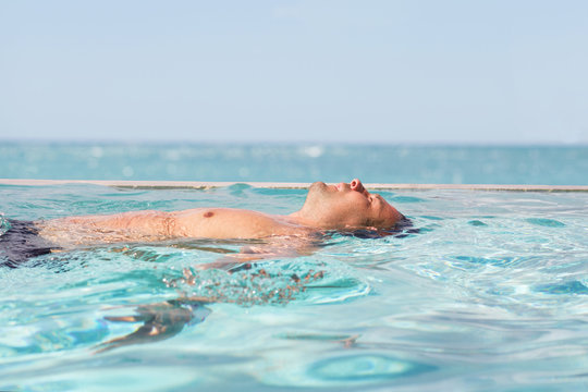 Man relaxing in the swimming pool
