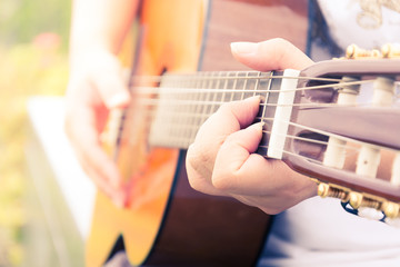  hand playing on  guitar