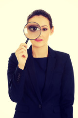 Businesswoman with magnifier glass.