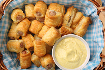 German frankfurter sausages in puff pastry with mustard sauce