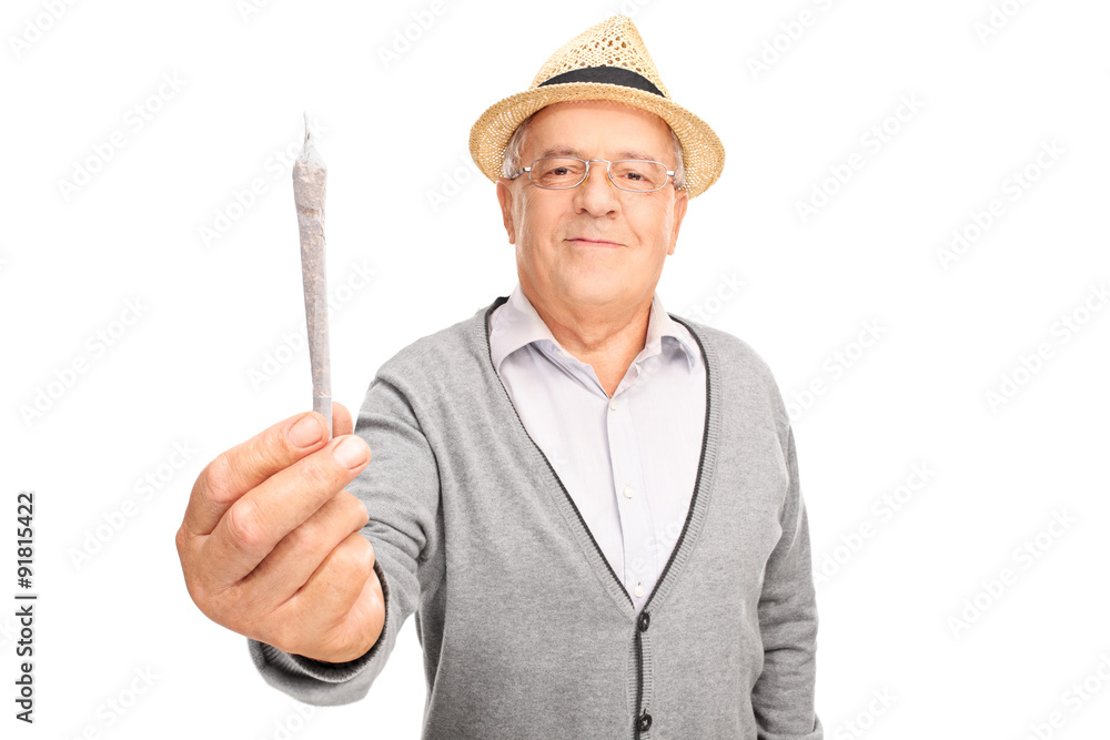 Poster Cheerful mature man holding medicinal marijuana