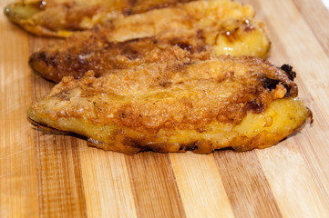 Fried stuffed paprika with cheese on the wooden board