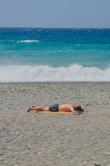 Fototapeta na wymiar man lying in the beach
