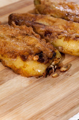 Fried stuffed paprika with cheese on the wooden board