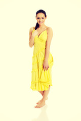 Fototapeta na wymiar Beautiful female model in yellow dress.