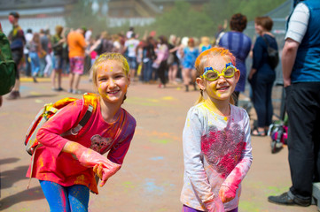 Two cute european sisters child girls celebrate Indian holi fest