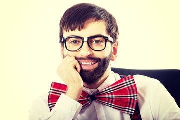 Young old fashioned man sitting by a desk.