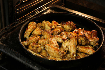 Chicken wings are baked in the oven