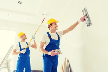 group of builders with tools indoors