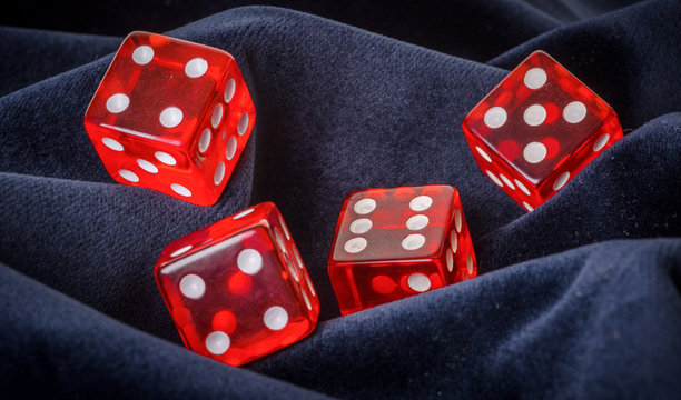 red dice on a blue velvet background