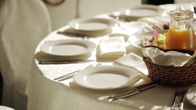A soft toned image of a table setting with plate, napkin 