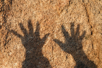 Hand shadow on stone