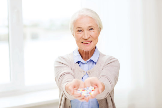 happy senior woman with medicine at home