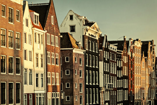 Retro styled image of ancient canal houses in Amsterdam