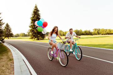 positive happy couple in love ride bicycles have fun