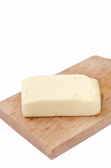Slice of butter on the wooden board