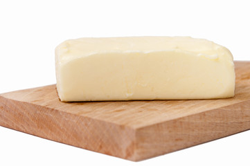 Slice of butter on the wooden board