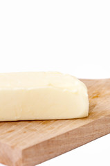 Slice of butter on the wooden board