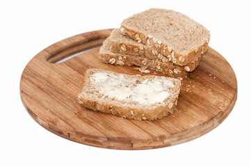 Brown bread with seeds coated with butter