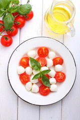 Italian caprese salad white plate on a white background