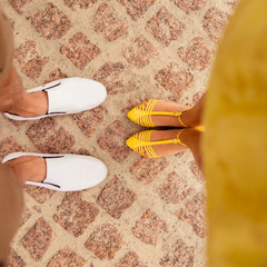legs of loving couples on the pavement