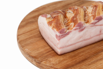 A piece of smoked bacon on wooden board