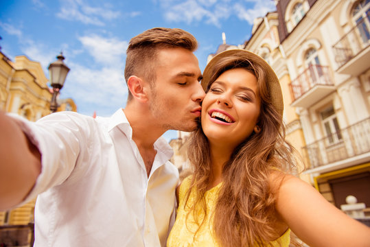 couple making selfie photo with kiss