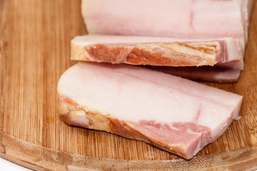Sliced smoked bacon on the wooden board