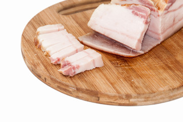 Slices of smoked bacon on the kitchen cutting board