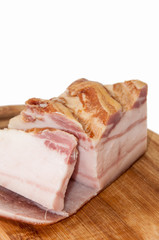 Slices of smoked bacon on the kitchen cutting board