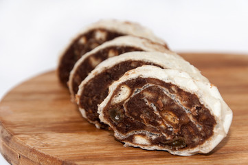 Chocolate roll cake on a wooden board