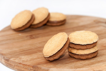 Chocolate sandwich biscuits on the wooden board