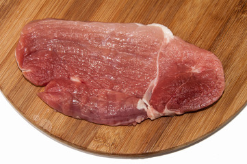 Pork tenderloin on a kitchen wooden board
