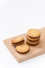 Fototapeta na wymiar Chocolate sandwich biscuits on the wooden board