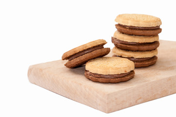 Chocolate sandwich biscuits on the wooden board
