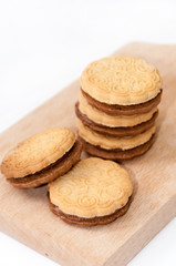 Chocolate sandwich biscuits on the wooden board