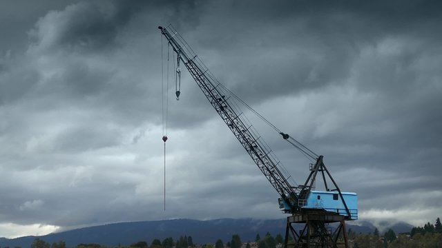 Large Crane With Mountains And Stormy Sky