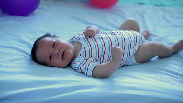 Crying infant lying on his back