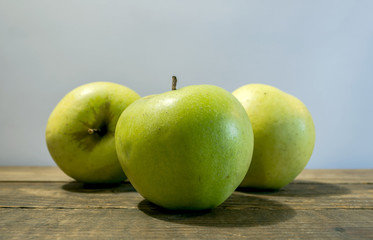 Green apple fruits isolated on wooden gray background