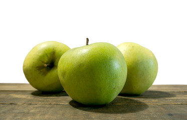 Green apple fruits isolated on wooden white background