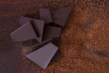 close up of  chocolate and cacao powder on wooden table - studio