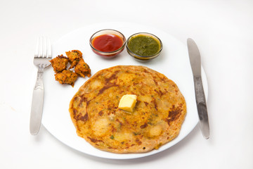 aalloo parantha and pakode an ideal indian breakfast served with tomato sauce or ketchup and green chutney