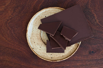 close up of  chocolate on a plate on wooden background - studio