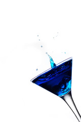 Blue cocktail splash in martini glass