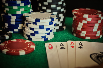 Poker Chips on a gaming table with cards