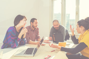 Young group of people/architects discussing business plans.