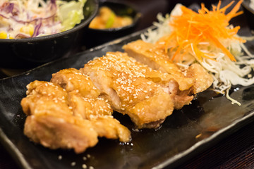Teriyaki chicken on black plate