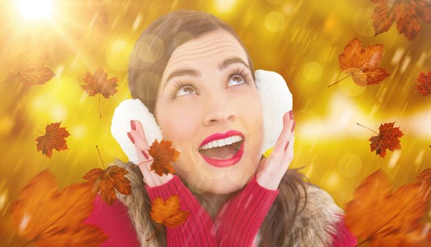 Composite image of surprised brunette in winter clothes 