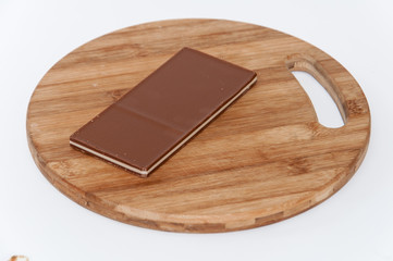 Brown white chocolate on a wooden board